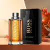 Hugo Boss The Scent 100ml Eau de Toilette Spray in a stylish amber glass bottle with metallic details.​