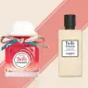 Close-up of Hermès Tutti Twilly d’Hermès set showcasing the fragrance bottle adorned with a silk ribbon and matching body lotion