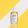 Maison Margiela EDT in classic clear bottle near firewood