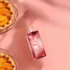Close-up of Idole Power Intense fragrance with dynamic pink-rose visuals