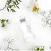 Elegant white bottle of Valaya with glowing feminine aroma