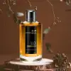 Luxurious oud perfume with peach, jasmine, and warm balsam